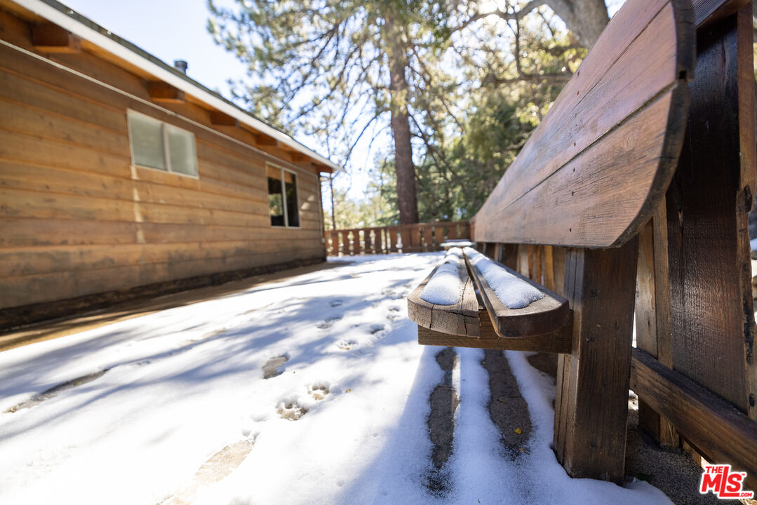 5212 Lone Pine Canyon Road Wrightwood, CA 92397 - Photo 33 of 42 a backyard of a house with table and chairs
