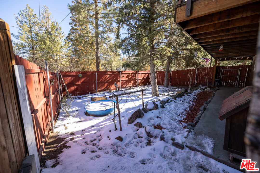 5212 Lone Pine Canyon Road Wrightwood, CA 92397 - Photo 40 of 42 a view of a backyard with chairs and a grill