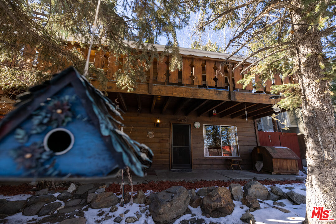 5212 Lone Pine Canyon Road Wrightwood, CA 92397 - Photo 42 of 42 a wooden bench sitting in front of a building