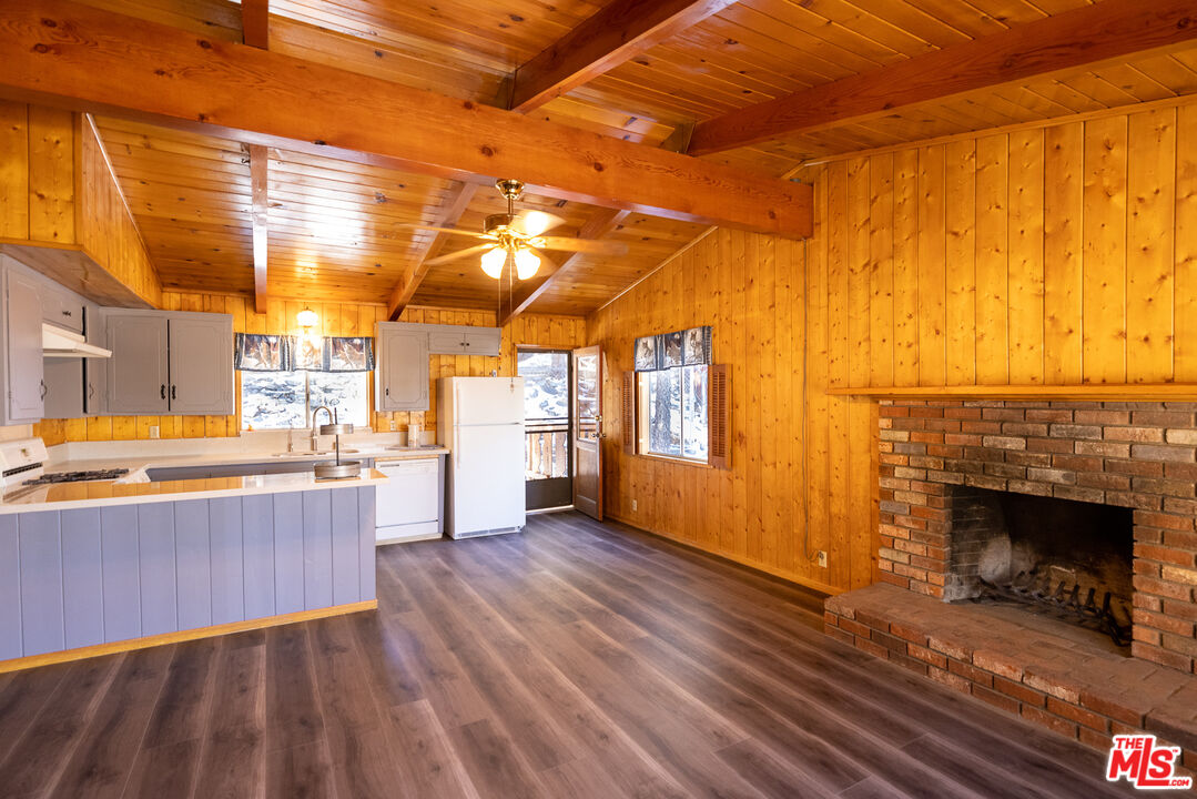 5212 Lone Pine Canyon Road Wrightwood, CA 92397 - Photo 6 of 42 a view of a room with wooden floor and a fireplace