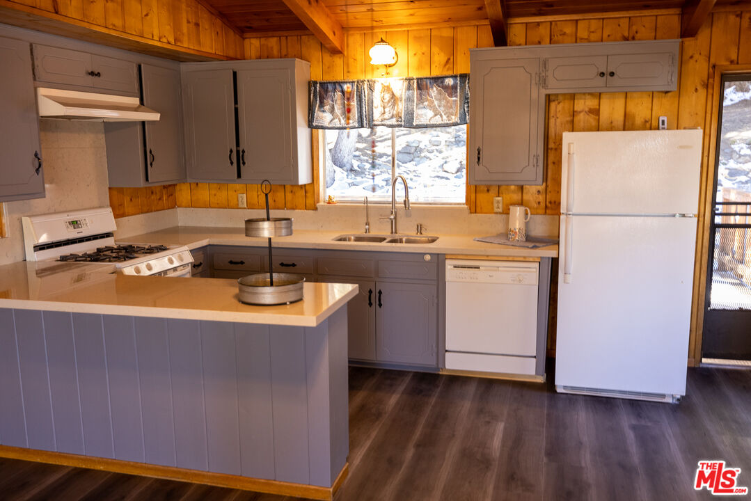 5212 Lone Pine Canyon Road Wrightwood, CA 92397 - Photo 7 of 42 a kitchen with stainless steel appliances a sink a stove and a refrigerator