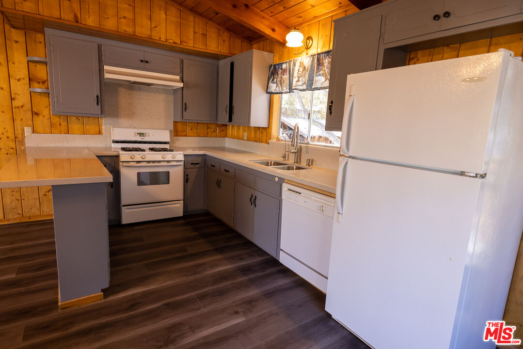 5212 Lone Pine Canyon Road Wrightwood, CA 92397 - Photo 8 of 42 a white refrigerator freezer sitting inside of a kitchen