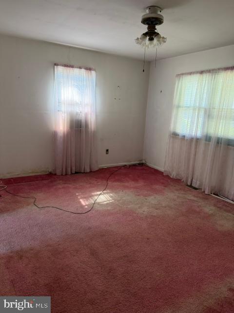 106 Fischer Road Grasonville, MD 21638 - Photo 4 of 8 an empty room with windows and fan