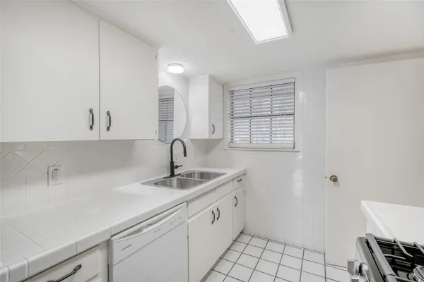 a kitchen with a sink and cabinets
