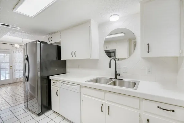 a kitchen with a sink and refrigerator