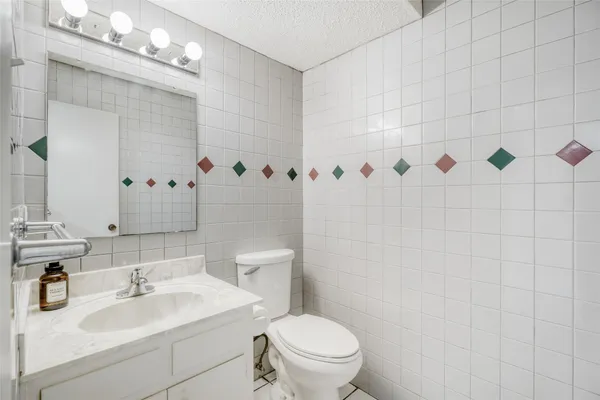 a bathroom with a sink a toilet and shower curtain