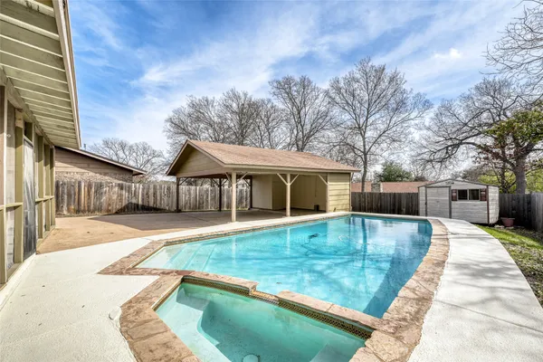 a view of house with swimming pool and sitting area