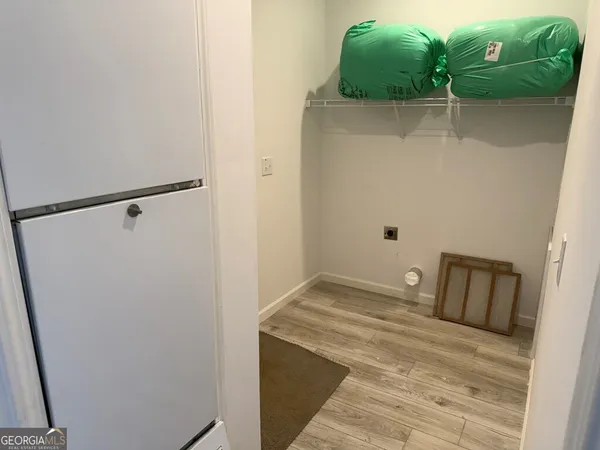 a view of hallway with wooden floor