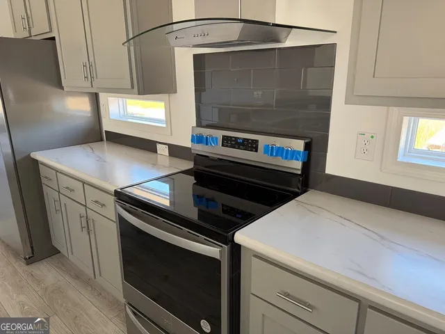 a kitchen with a stove and a microwave