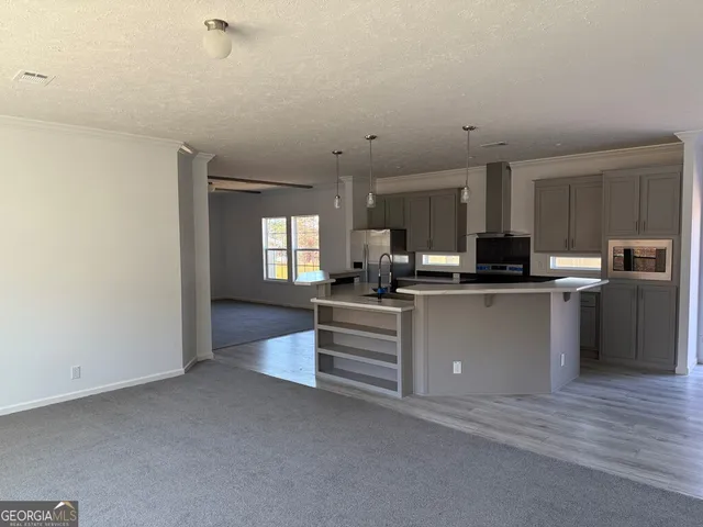 a kitchen with cabinets and stainless steel appliances