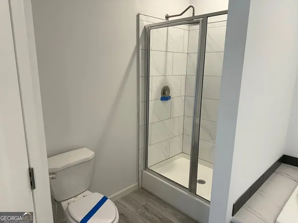 a bathroom with a shower and a sink