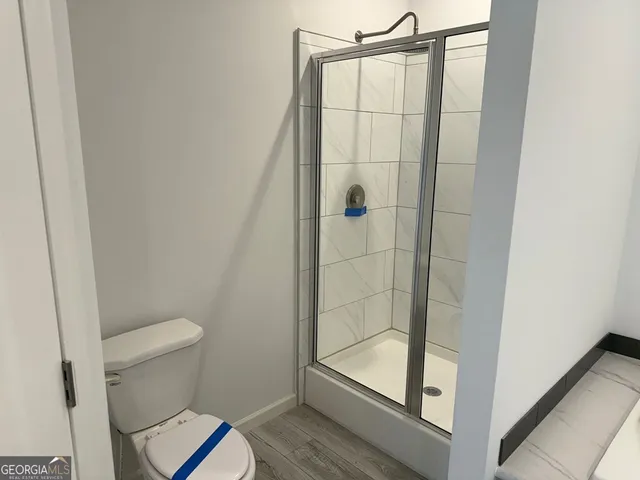 a bathroom with a shower and a sink