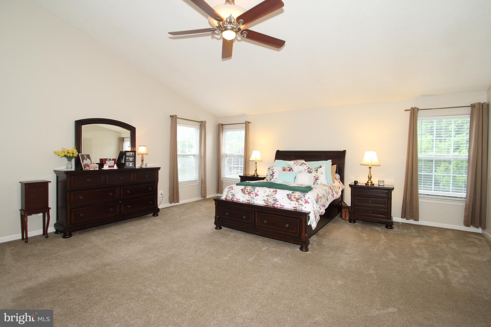 102 Patton Way Elkton, MD 21921 - Photo 15 of 27 a spacious bedroom with a bed and a chandelier