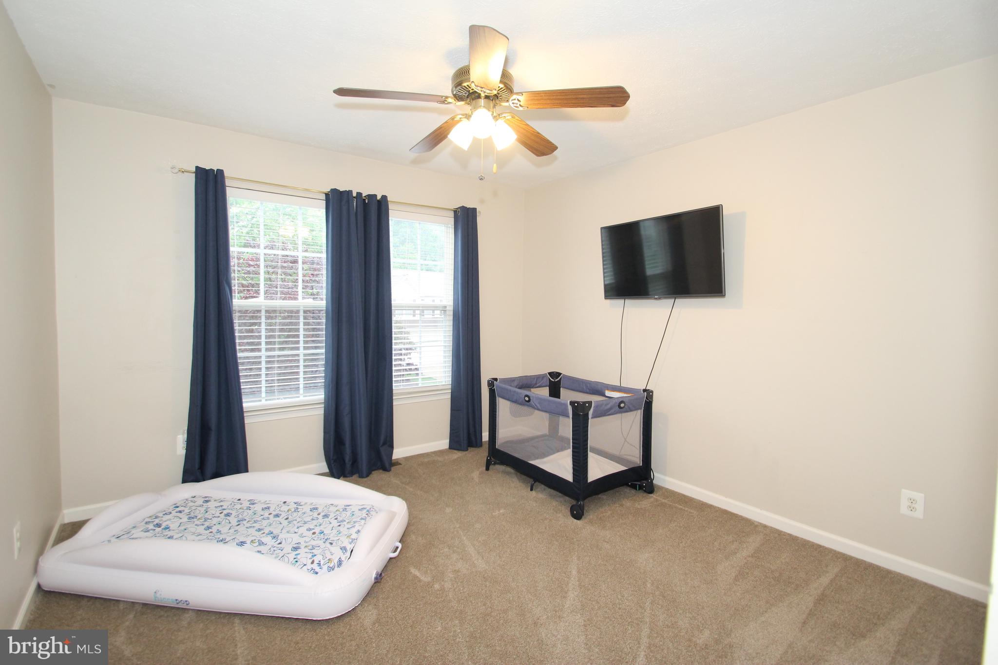 102 Patton Way Elkton, MD 21921 - Photo 19 of 27 a bedroom with a bed and a flat screen tv