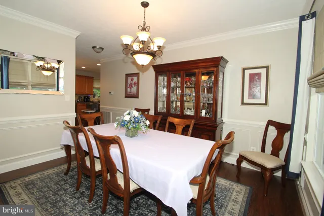 a view of a dining room with furniture and chandelier