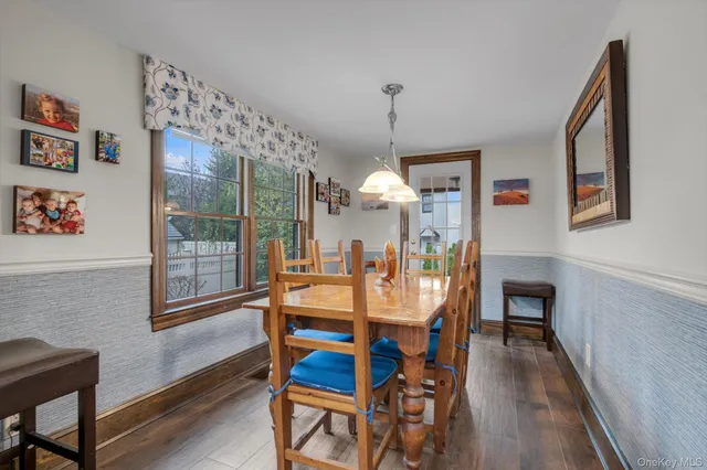 a view of a dining room with furniture wooden floor and a chandelier