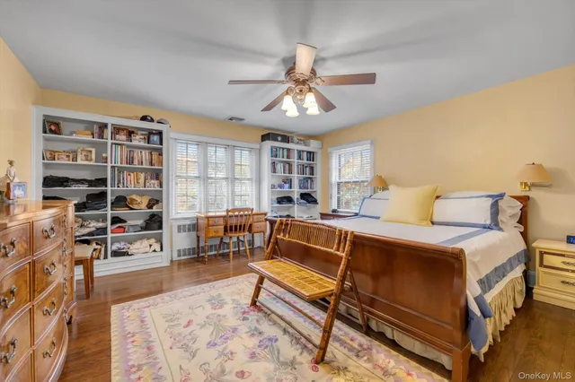 a bedroom with furniture and a book shelf