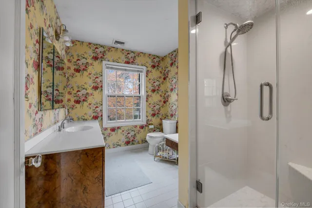 a bathroom with a sink toilet and shower