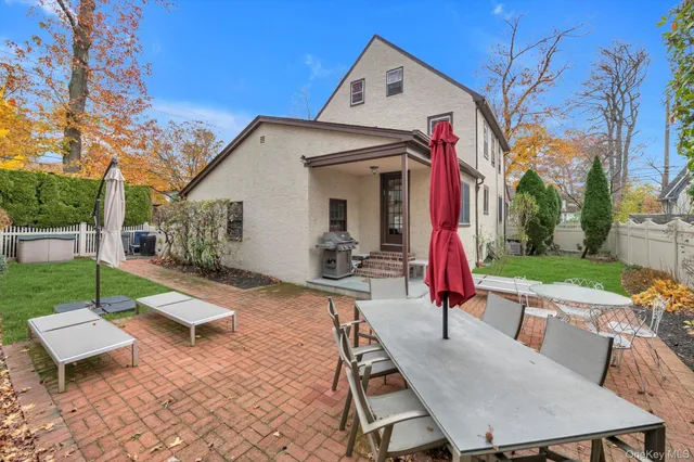 a view of a patio with a table and chairs