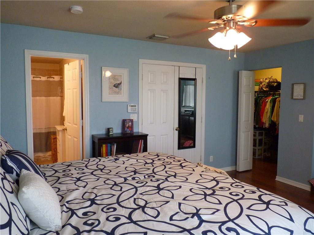 5298 Southeast Mitchell Lane Stuart, FL 34997 - Photo 12 of 33 a bedroom with a bed and a chandelier