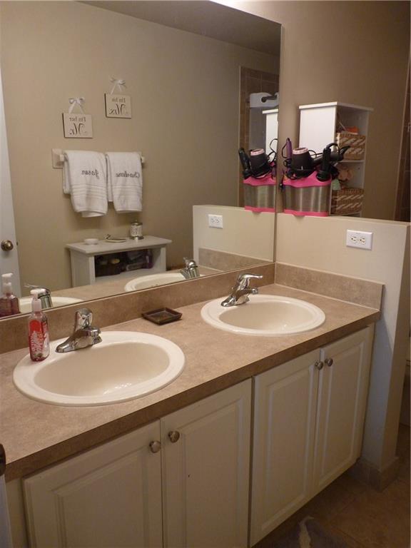 5298 Southeast Mitchell Lane Stuart, FL 34997 - Photo 15 of 33 a bathroom with double sink and a mirror