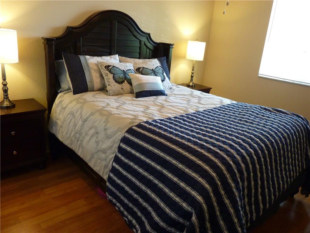 5298 Southeast Mitchell Lane Stuart, FL 34997 - Photo 19 of 33 a bedroom with a bed and a painting on the wall
