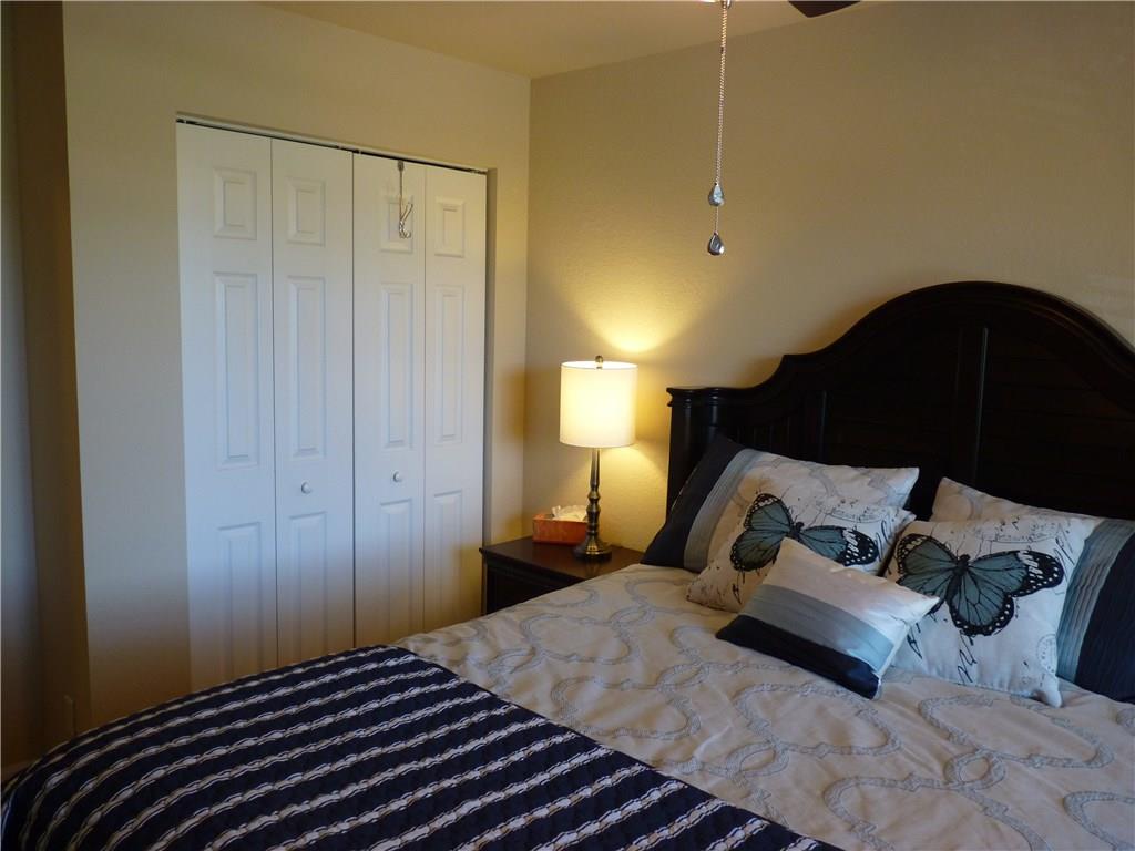 5298 Southeast Mitchell Lane Stuart, FL 34997 - Photo 20 of 33 a bedroom with a bed and a lamp on the dresser
