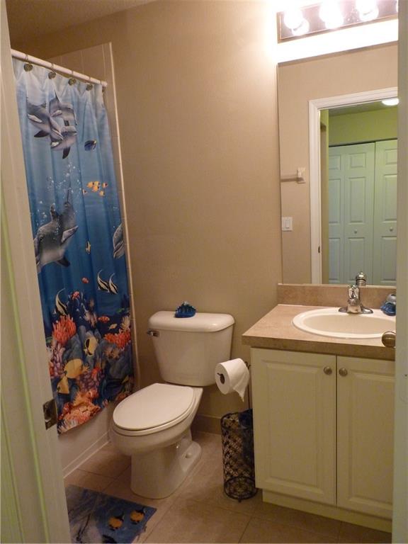 5298 Southeast Mitchell Lane Stuart, FL 34997 - Photo 21 of 33 a bathroom with a toilet sink and mirror