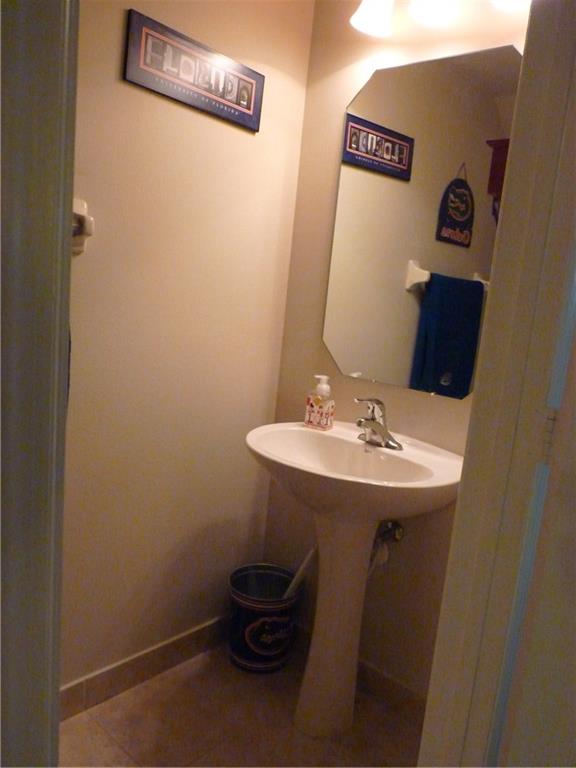 5298 Southeast Mitchell Lane Stuart, FL 34997 - Photo 25 of 33 a bathroom with a sink and a mirror