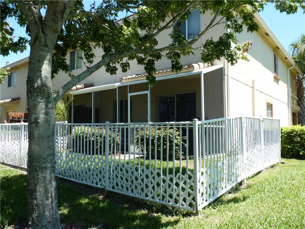 5298 Southeast Mitchell Lane Stuart, FL 34997 - Photo 29 of 33 a view of a house with a small yard and large trees