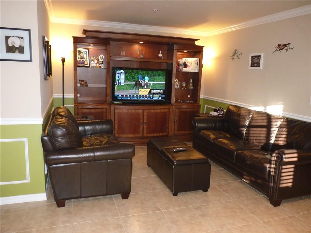 5298 Southeast Mitchell Lane Stuart, FL 34997 - Photo 3 of 33 a living room with furniture and a flat screen tv