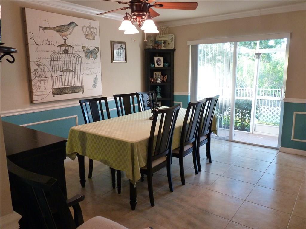 5298 Southeast Mitchell Lane Stuart, FL 34997 - Photo 10 of 33 a view of a dining room with furniture wooden floor and chandelier