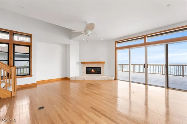 wooden floor chandelier and windows in an empty room