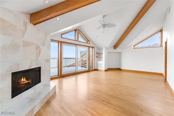 a view of an empty room with a fireplace and a window