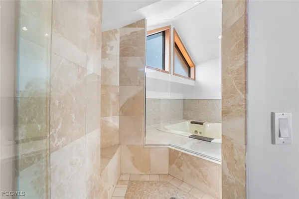 a bathroom with a bathtub and shower