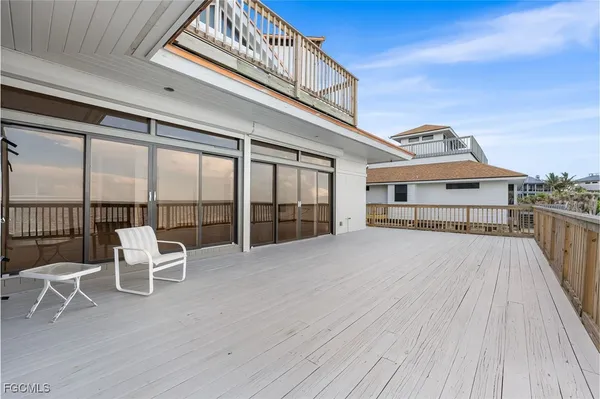 a view of a balcony with table and chairs