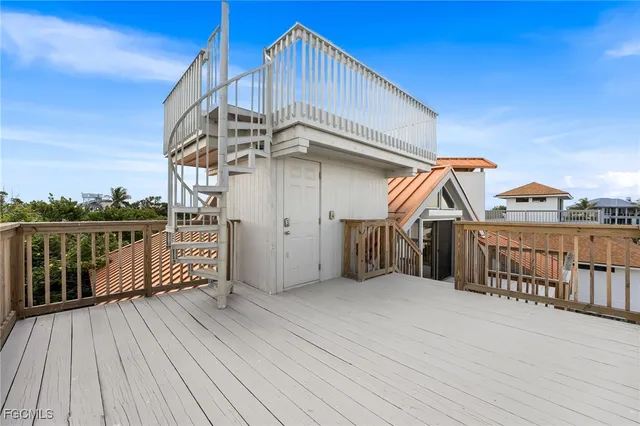 a view of a house with wooden deck