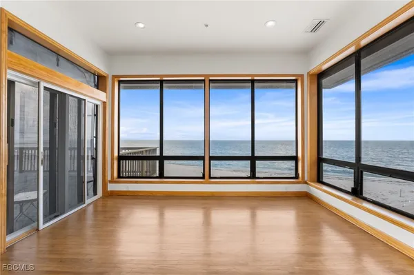 a view of an empty room with wooden floor
