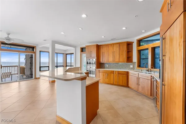 a large kitchen with stainless steel appliances granite countertop a large counter top and a stove