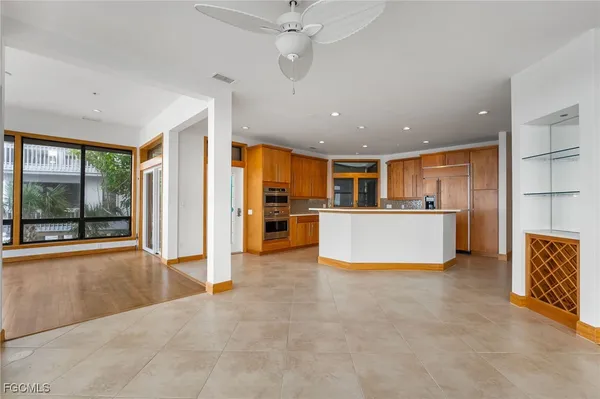 a view of kitchen with stainless steel appliances refrigerator oven and cabinets