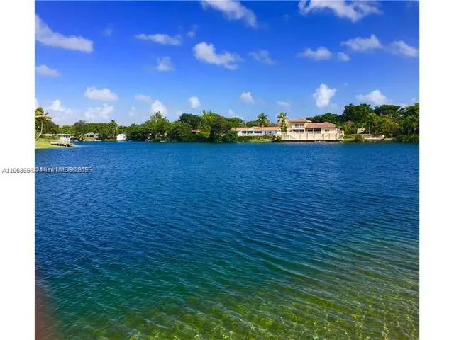 an aerial view of a house with a lake view