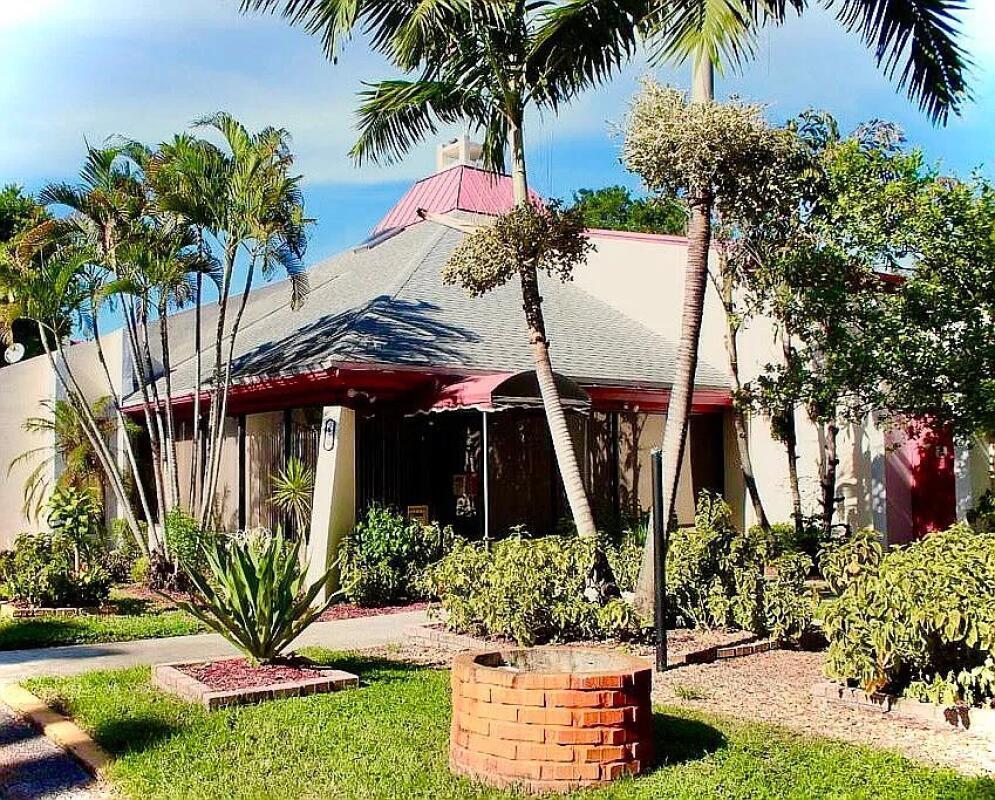 610 Northwest 13th Street, Unit 23 Boca Raton, FL 33486 - Photo 6 of 28 a view of a house with a yard and potted plants