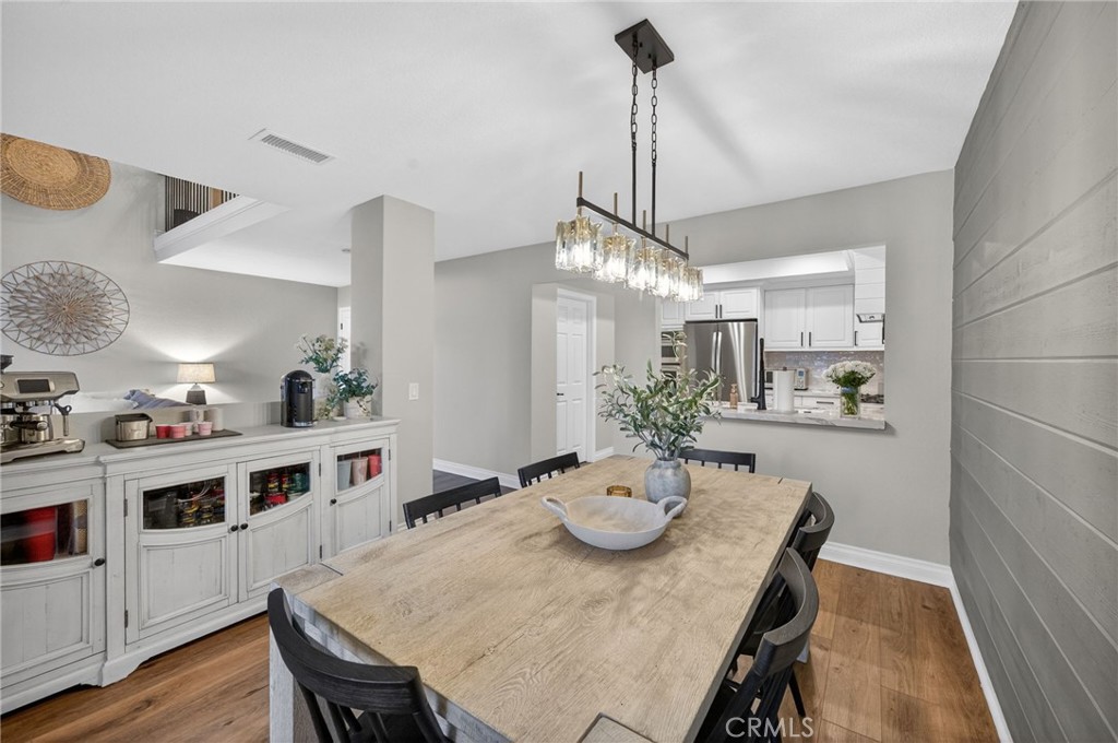 964 South Rim Crest Drive Anaheim, CA 92807 - Photo 23 of 69 a view of a dining room and livingroom with furniture wooden floor a rug a chandelier