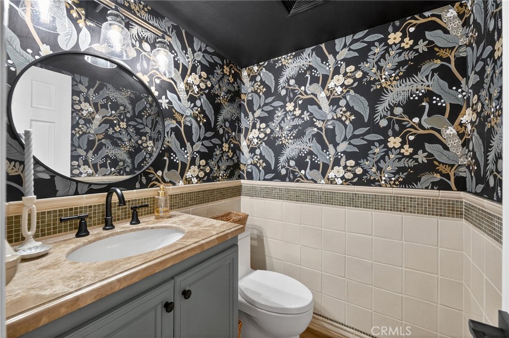 964 South Rim Crest Drive Anaheim, CA 92807 - Photo 32 of 69 a bathroom with a granite countertop sink and mirror