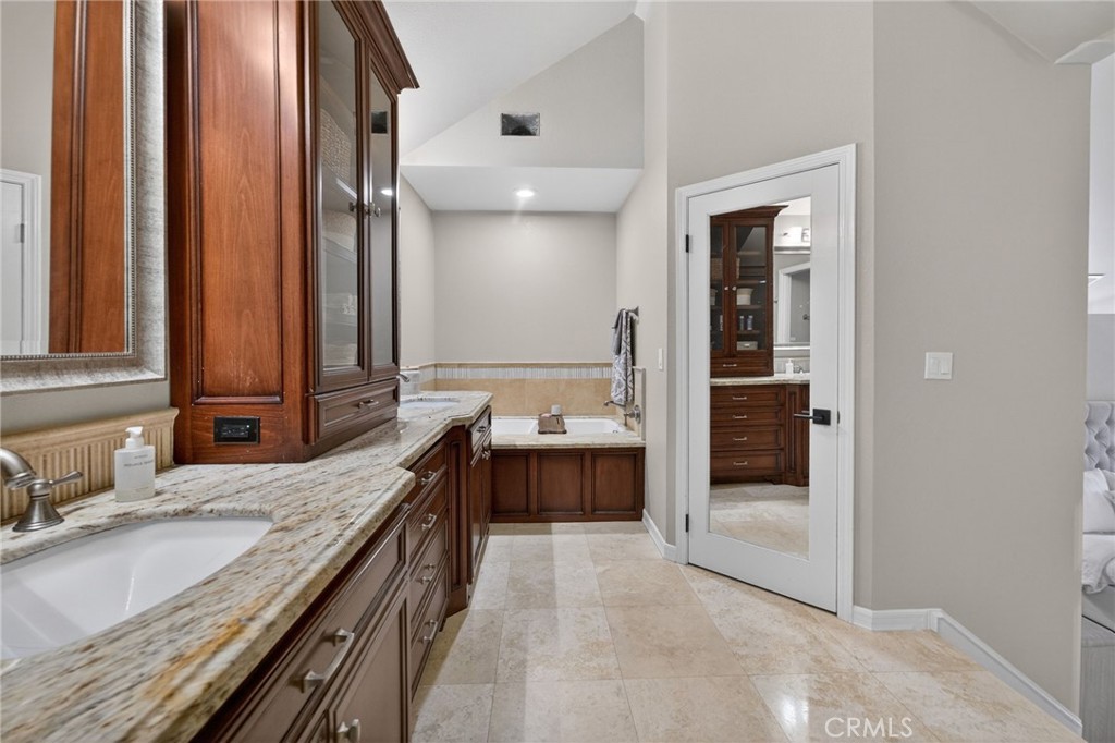 964 South Rim Crest Drive Anaheim, CA 92807 - Photo 39 of 69 a spacious bathroom with a granite countertop tub sink and mirror