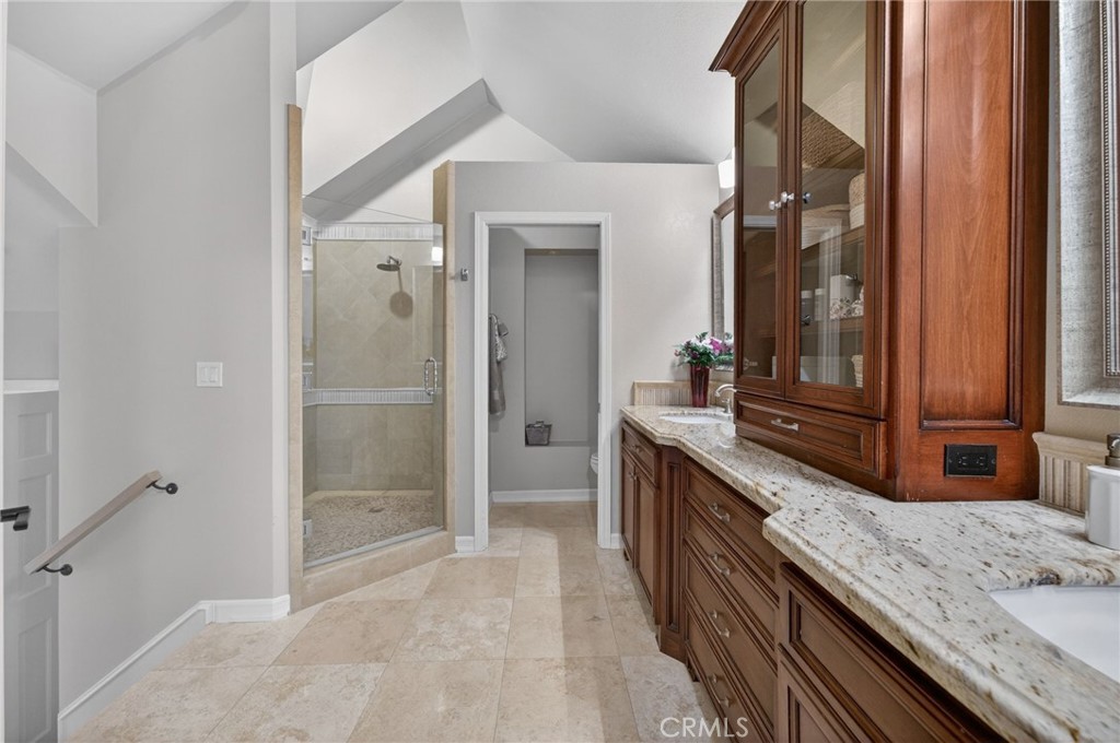 964 South Rim Crest Drive Anaheim, CA 92807 - Photo 41 of 69 a bathroom with a granite countertop double vanity sink and mirror