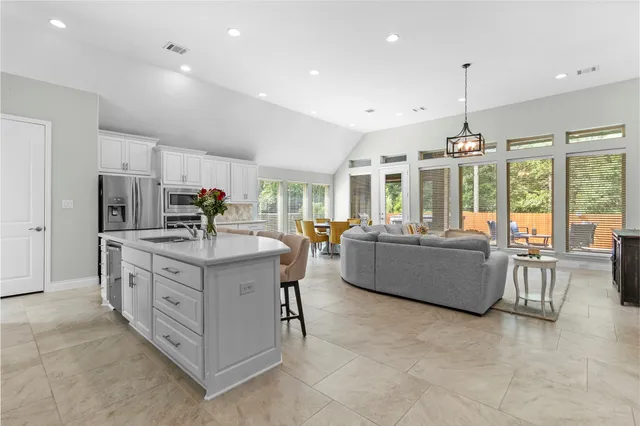 a kitchen with stainless steel appliances granite countertop a stove and a refrigerator
