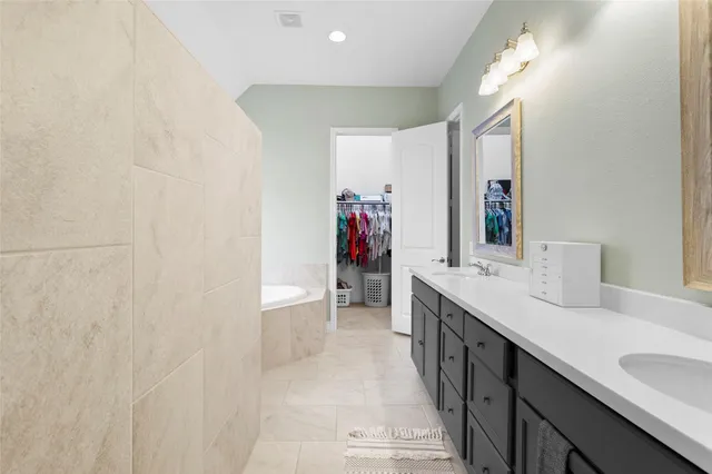 a bathroom with a double vanity sink and a mirror