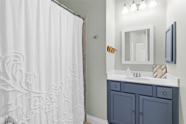 a bathroom with a double vanity sink and a mirror