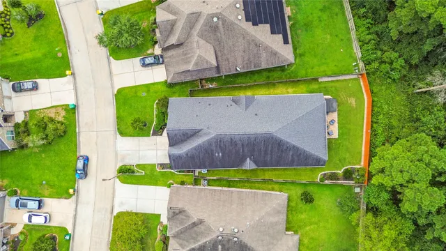 an aerial view of a house with garden space and street view